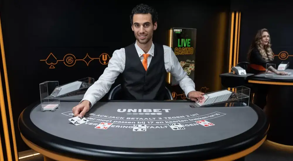 Table de live blackjack sur Unibet Casino avec croupier en direct, cartes distribuées et ambiance de casino en ligne belge